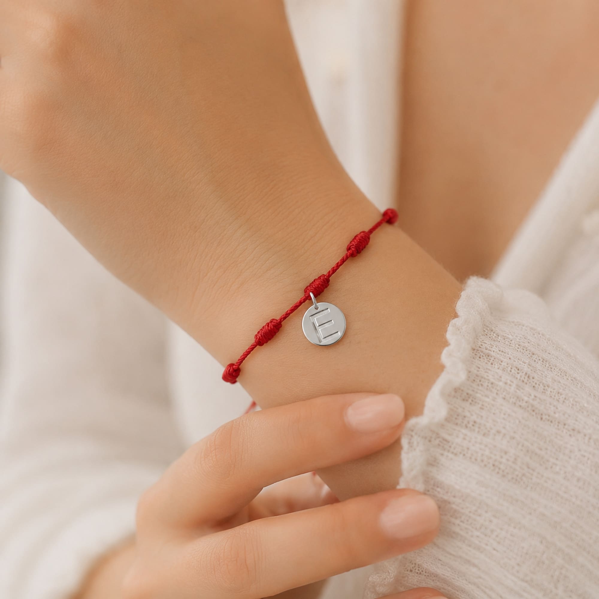 PULSERA 7 NUDOS CON LETRA E COLOR PLATEADO