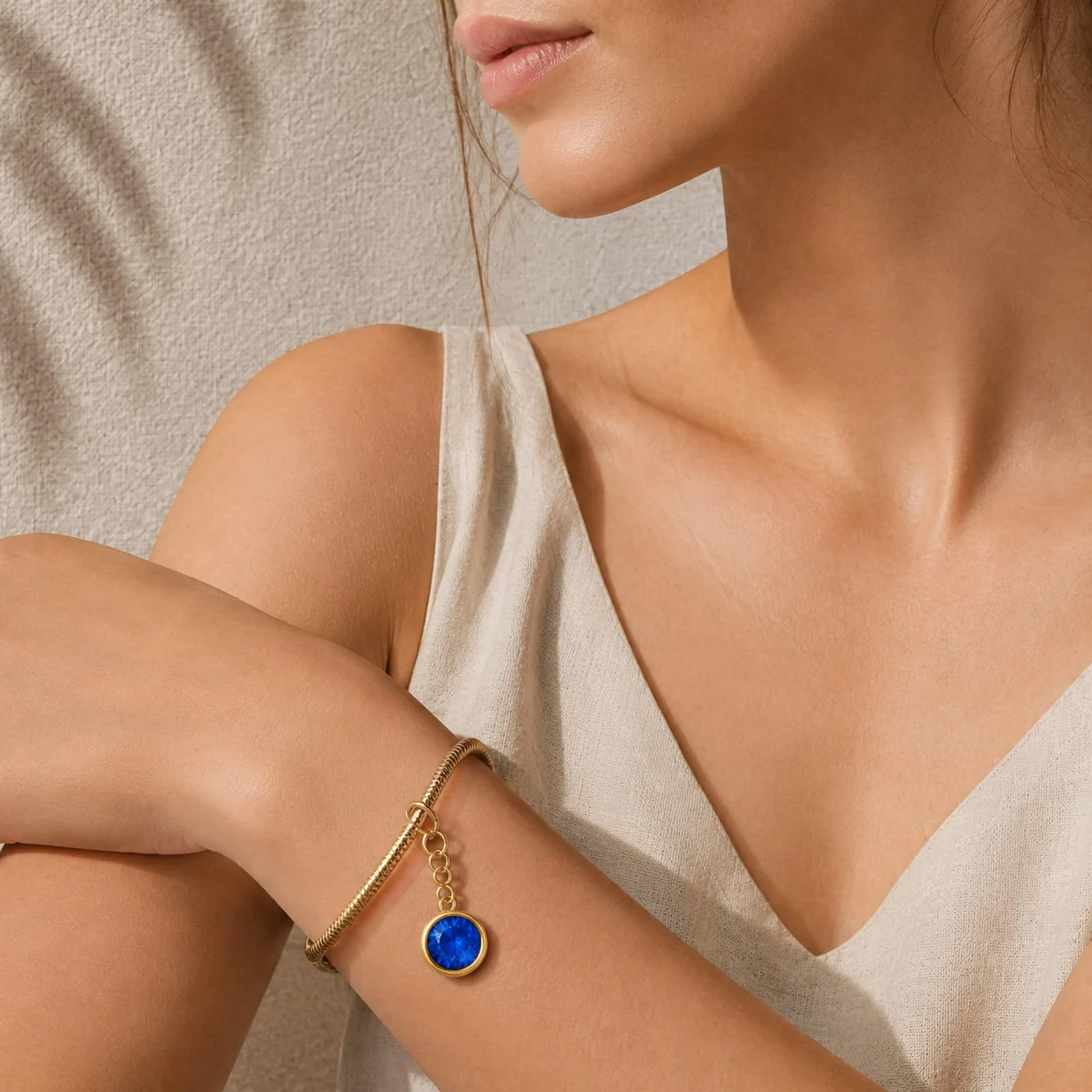 CHARM ACERO DORADO CON PIEDRA NACIMIENTO DE SEPTIEMBRE-CON CIERRE