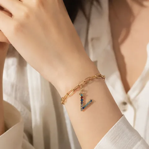 CHARM DE LETRA V ACERO COLOR DORADO CON CIRCONITA