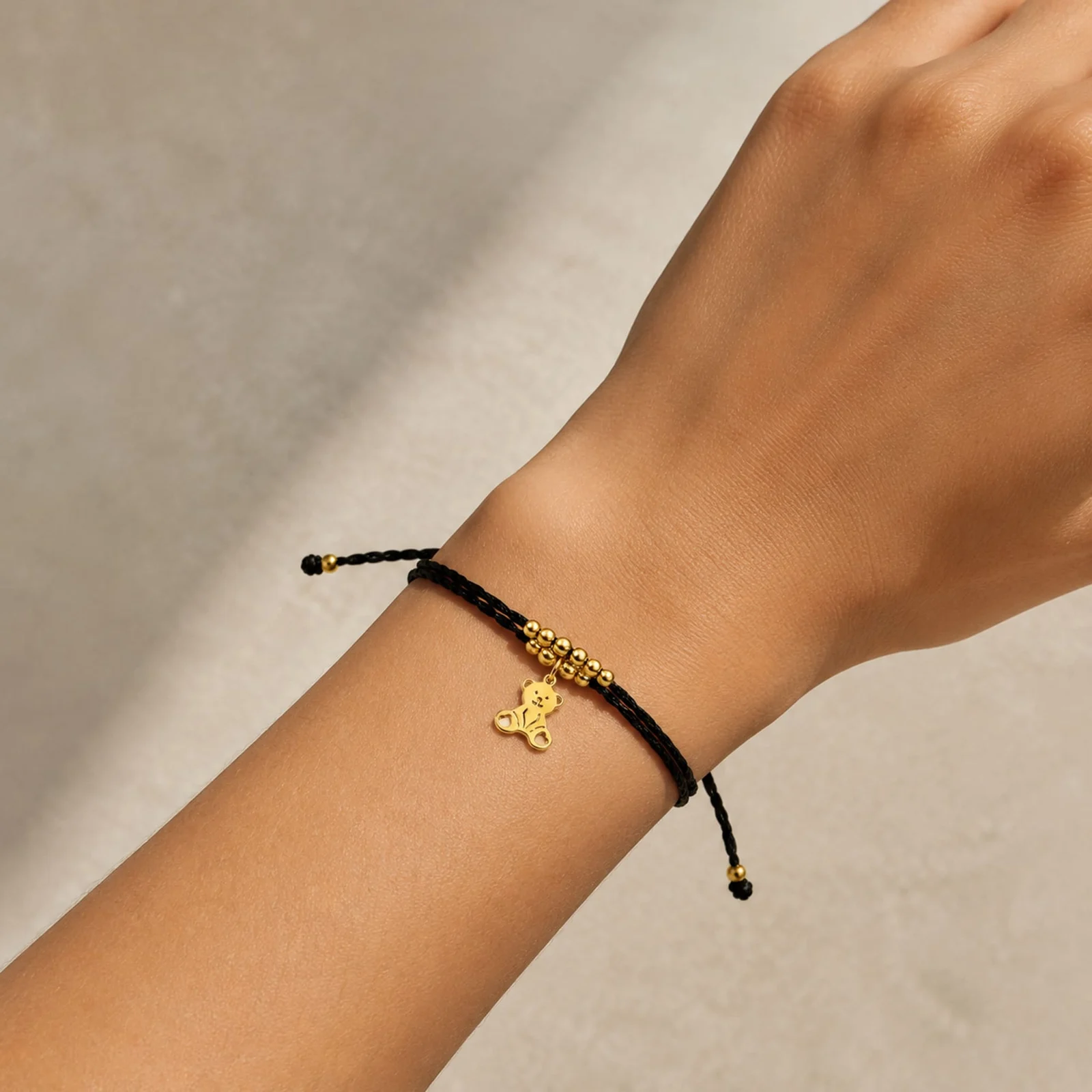 PULSERA HILO ENCERADO CON COLGANTE OSO ACERO DORADO